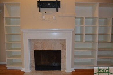 Fireplace and custom built shelves on either side.