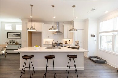 Huge, 9 ft quartz island paired with linen soft close cabinets  *Photos are of stagged home. Photos shown are not actual unit.*