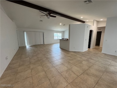 Unfurnished room with a ceiling fan, arched walkwa