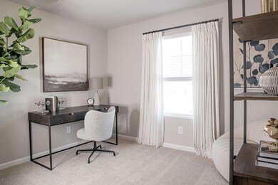 Carpeted home office with plenty of natural light 