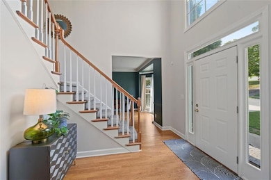Foyer entrance featuring a high ceiling, wood fini