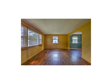 Arched passageway opens to the formal dining room