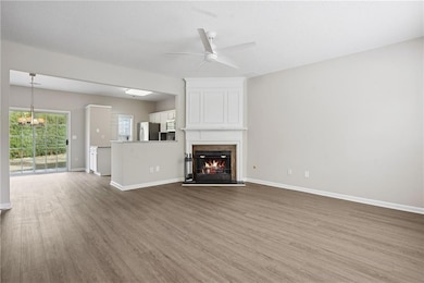 Unfurnished living room featuring baseboards, a ce
