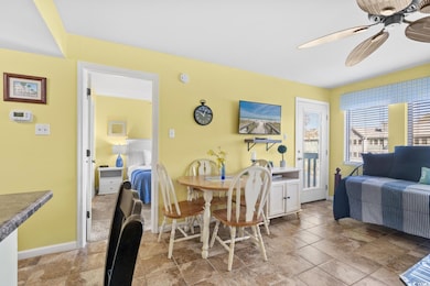 Dining area featuring ceiling fan and baseboards