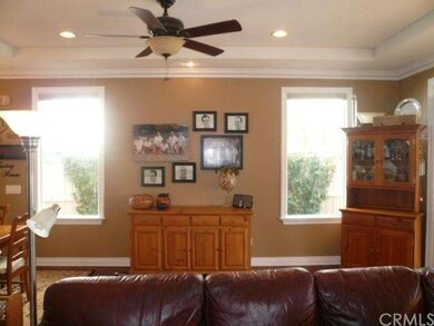 Dining room with wood floors, ceiling fan and slid