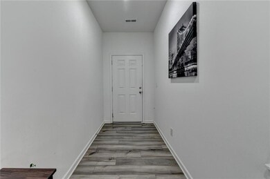 Hall with light wood-type flooring and baseboards