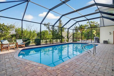 Swimming pool with a sunroom, a lanai, and a patio area