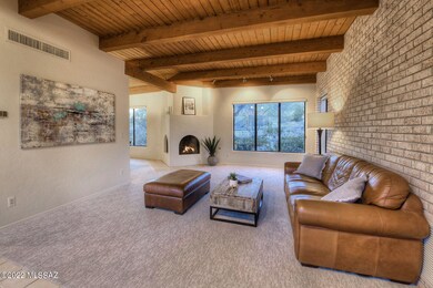 Living Room w/ Beam Ceiling & Firplc