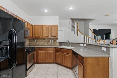 Kitchen featuring tasteful backsplash, a sink, bro