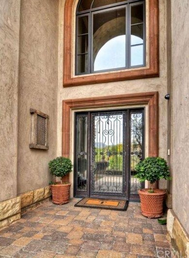 Massive entry with 2-story foyer. Custom wrought i