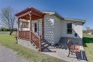 BackSide of property featuring a pergola, a lawn, 