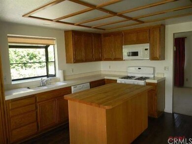 The kitchen features an abundance of cupboards and