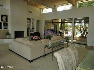 Living room wall of windows looks out to