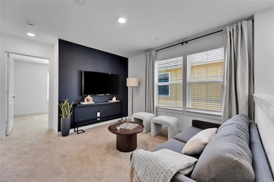 Living room with carpet floors, baseboards, and recessed lighting
