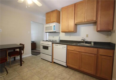 Eat In Kitchen with dishwasher - gas stove. Ample counter space - vinyl flooring with ceiling fans and wood cabinets and a pantry