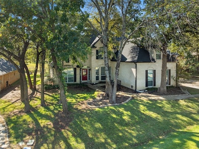 View of front of home featuring brick siding, a front lawn, roof with shingles, and crawl space