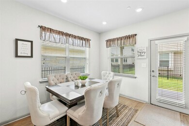 Dining space with wood finished floors and recessed lighting