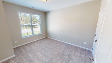 Empty room with carpet flooring and baseboards