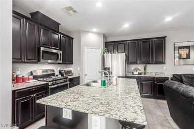 Kitchen featuring a sink, a kitchen island with si