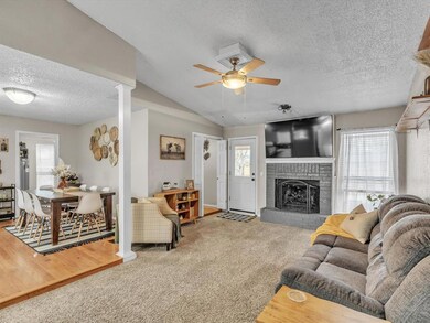 Living room featuring light colored carpet, plenty