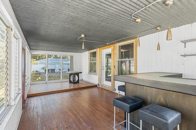 Unfurnished sunroom featuring a hot tub
