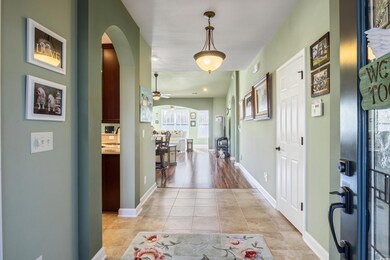 Hallway featuring light tile patterned floors