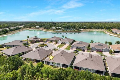 Drone / aerial view with a wooded view, a water vi