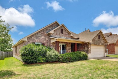 Traditional-style home with brick siding, a garag