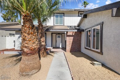 Entrance to property with stucco siding and brick