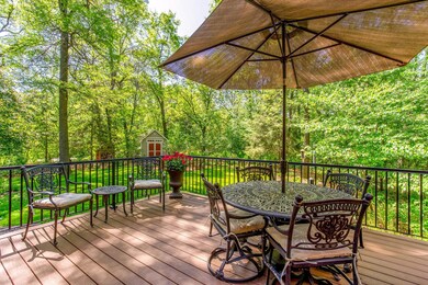 A charming outdoor retreat—dine al fresco beneath the trees, surrounded by serene, wooded beauty.