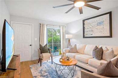 Living area featuring ceiling fan and hardwood / wood-style flooring