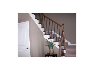 Dramatic staircase with iron spindles and oak end 