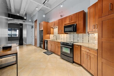 Modern kitchen with warm wooden cabinets, granite