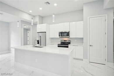 Kitchen with stainless steel appliances, marble fi