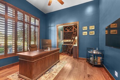 Home office with light wood-style floors, ceiling