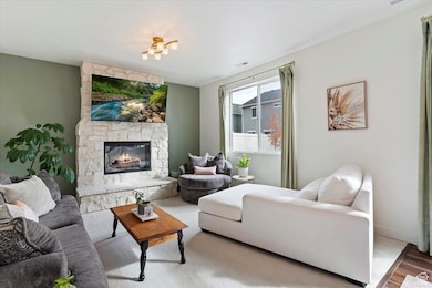 Living room featuring a stone fireplace and wood finished floors
