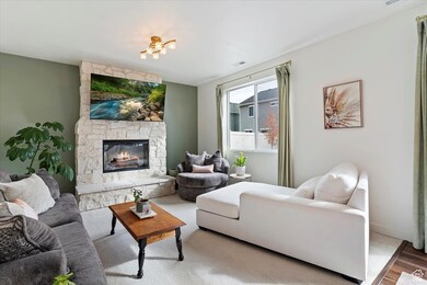 Living room featuring a stone fireplace and wood finished floors