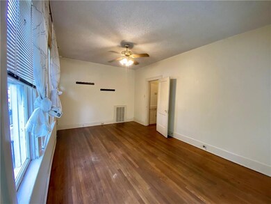 Spare room featuring baseboards, wood finished fl
