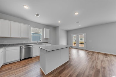 Kitchen featuring white cabinetry, visible vents, 