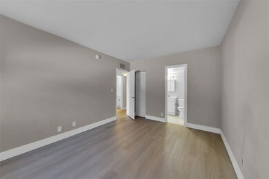 Master Bedroom with en-suite bathroom and wood lik