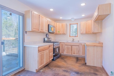 Kitchen with stainless steel appliances, sink, and