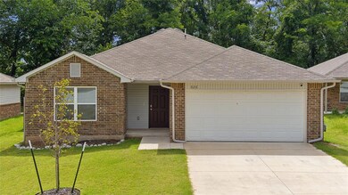 View of front of house with a front yard and a gar