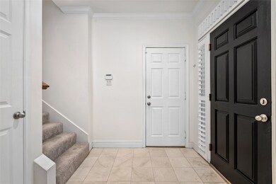 Natural light fills the entry foyer. Door to 2-car