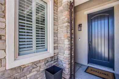 Doorway to property featuring stone siding