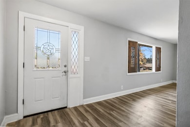 Bright entryway featuring a decorative front door