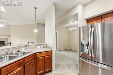 Kitchen with a sink, a fireplace, a skylight, dish