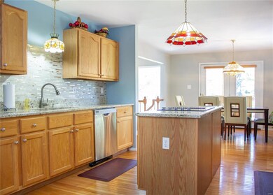 Updated Kitchen with New Granite Countertops & Tile Backsplash.