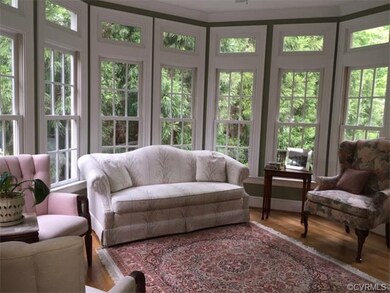 Library with hardwood floors, transom windows and 