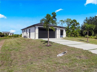 Garage featuring concrete driveway