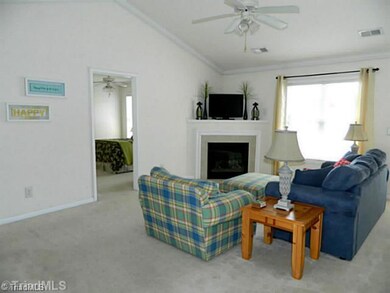 Living Room. Home has crown molding throughout and tons of natural light.